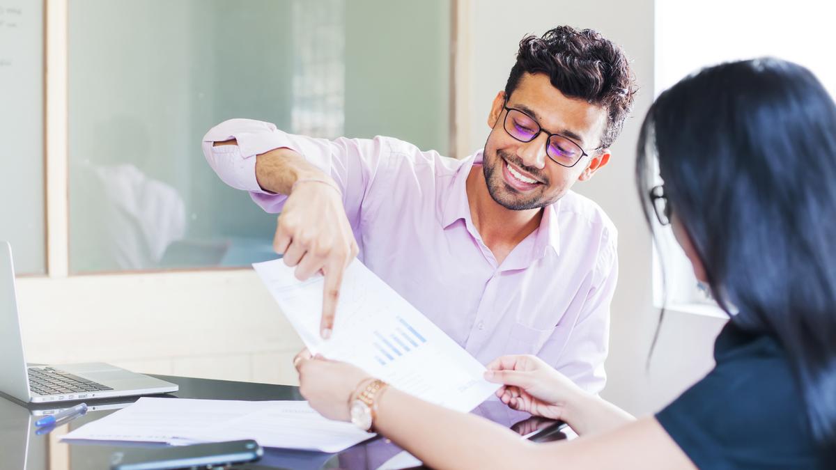 A manager reviewing and approving a report with a colleague