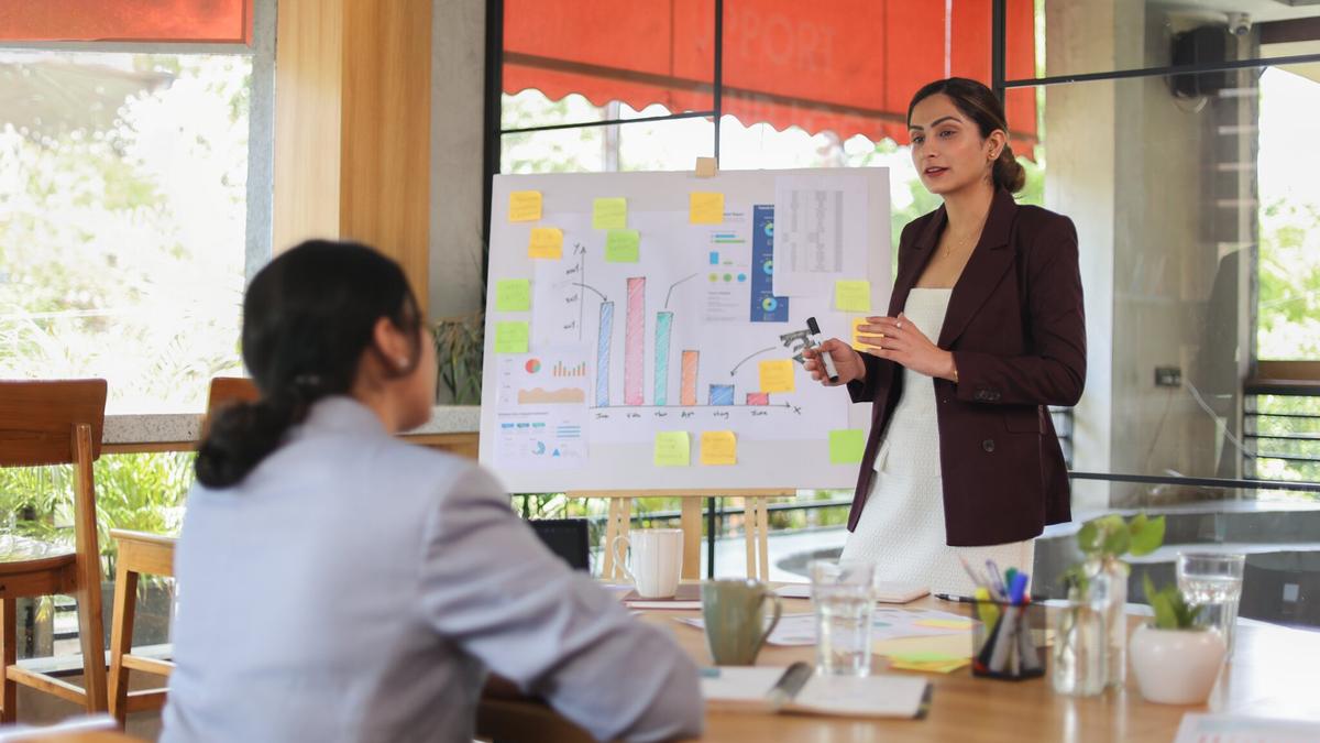 Manager presenting a goal progress chart to a colleague during a planning session